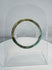 Ancient Roman polychrome glass bracelet displaying intricate striped decoration and archaeological iridescence.