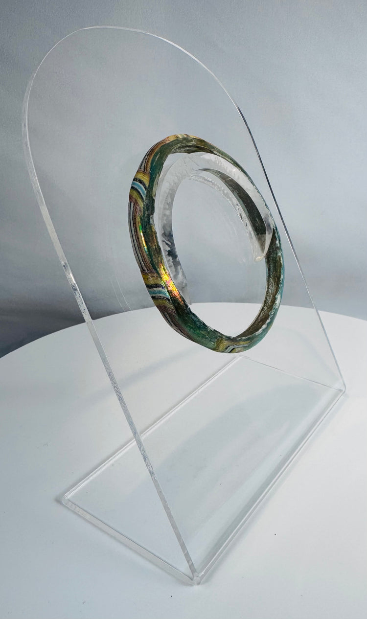 Authentic Roman mosaic glass bracelet featuring multicolored bands of green, yellow, white, blue, and black glass.