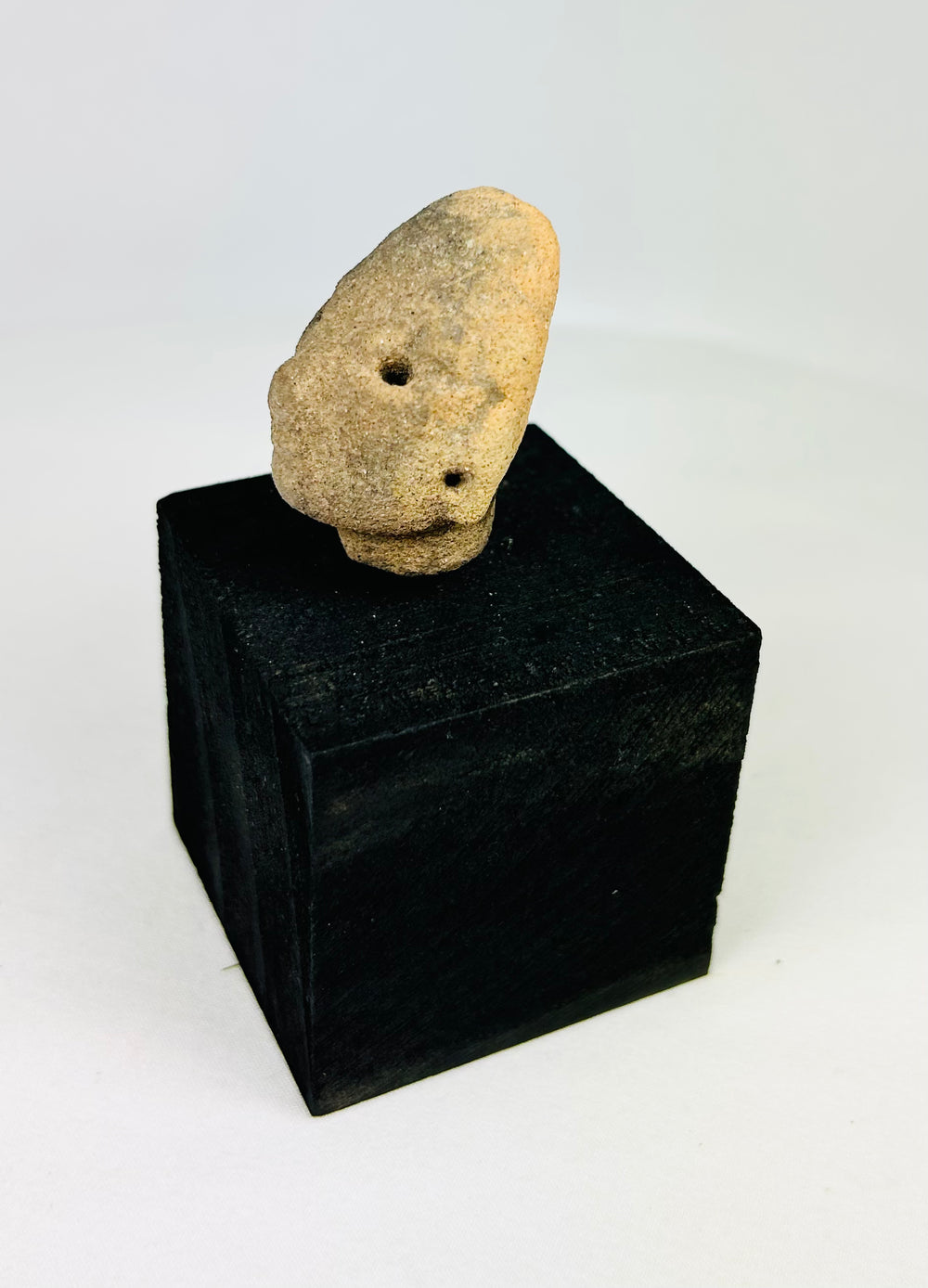 Pre-Columbian terracotta head from West Mexico, Nayarit or Jalisco, small collectible fragment with drilled eyes, rounded features, 300 BCE–300 CE