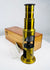 Victorian brass drum microscope featuring mirror illumination and telescoping eyepiece tube