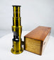 Antique portable brass microscope with fitted hardwood case and historical scientific accessories