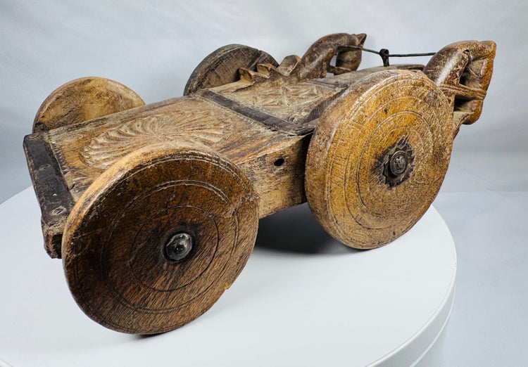 Antique Indian wooden cart with carved rosette motifs and solid wooden wheels