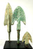 Frontal view of three ancient bronze dart points on black block