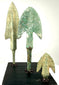 Close-up of cast bronze blade shapes with verdigris texture