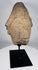 African sculptural stone fragment with conical headdress and solemn expression