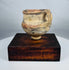Neolithic Chinese terracotta pottery vessel with painted mineral pigments and strap handle