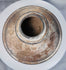 Ancient ritual pottery vessel with black painted bands and weathered surface