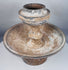 Terracotta ritual stand with mineral deposits and surviving painted decoration