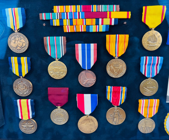 Vintage American naval service shadow box with embroidered patches and commemorative decorations