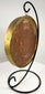 Gold-rimmed glass frame holding historical royal wax artifact