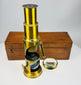Antique portable field microscope with adjustable mirror and telescoping eyepiece