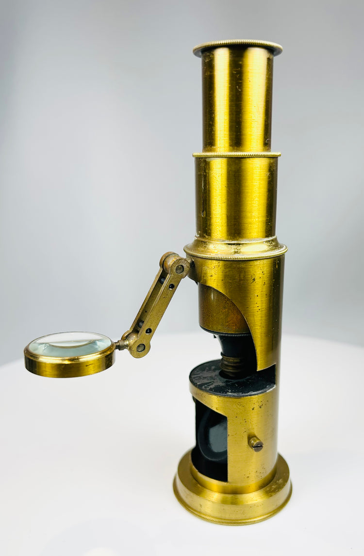 Compact 19th century microscope with swing out magnifier and mahogany storage case