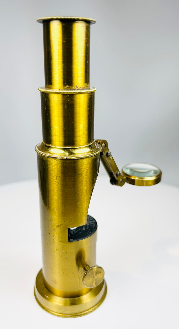 Historic field microscope showing mirror illumination and cylindrical brass design