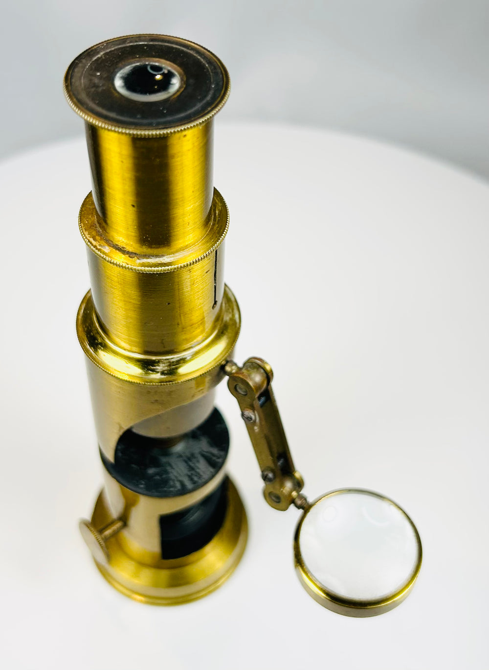 Victorian era portable microscope with aged patina and intact optical components