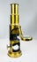 19th century portable brass microscope with mirror base and compact scientific design