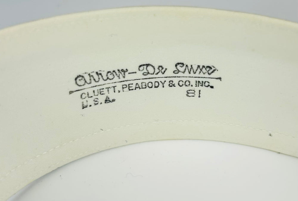 Edwardian collar box with ornate exterior and preserved linen collars