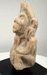 Ancient Northern Indian clay figurine with an elongated head, simplified body proportions, and weathered terracotta surfaces.