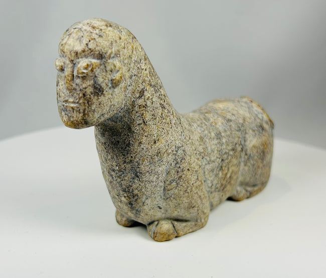 African tribal sculpture in stone with expressive eyes and minimalist design