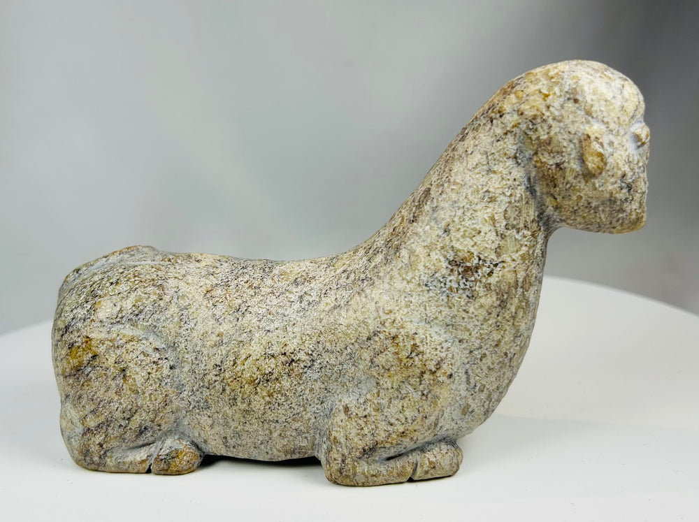 African stone sculpture with mottled tones and expressive carved details