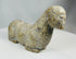 Hand carved tribal stone figure with abstract animal representation