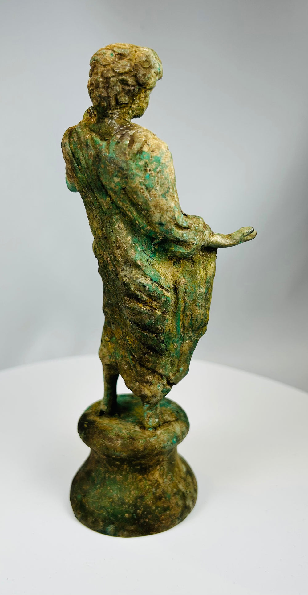 Vintage bronze draped figure with oxidized surface and classical design