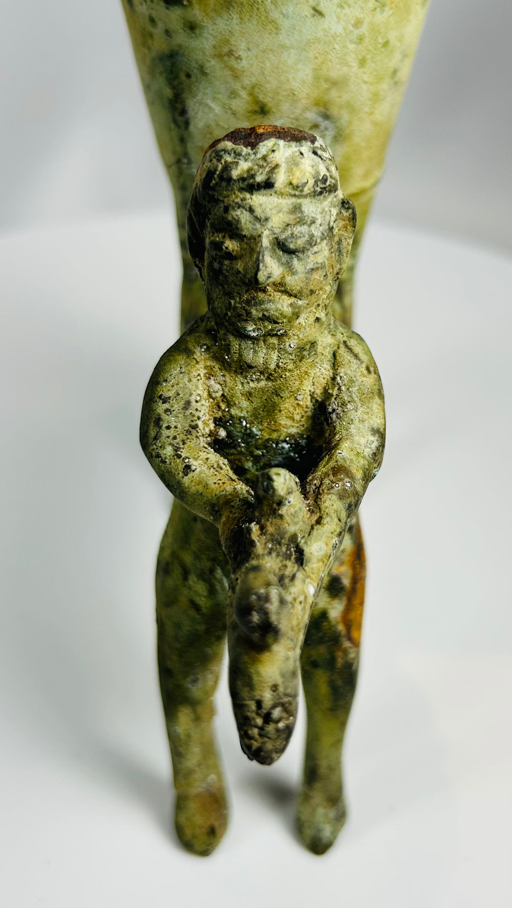 Decorative antique bronze rhyton with oxidized surface and mythic figure