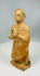 Stylized terracotta male sculpture with simplified features