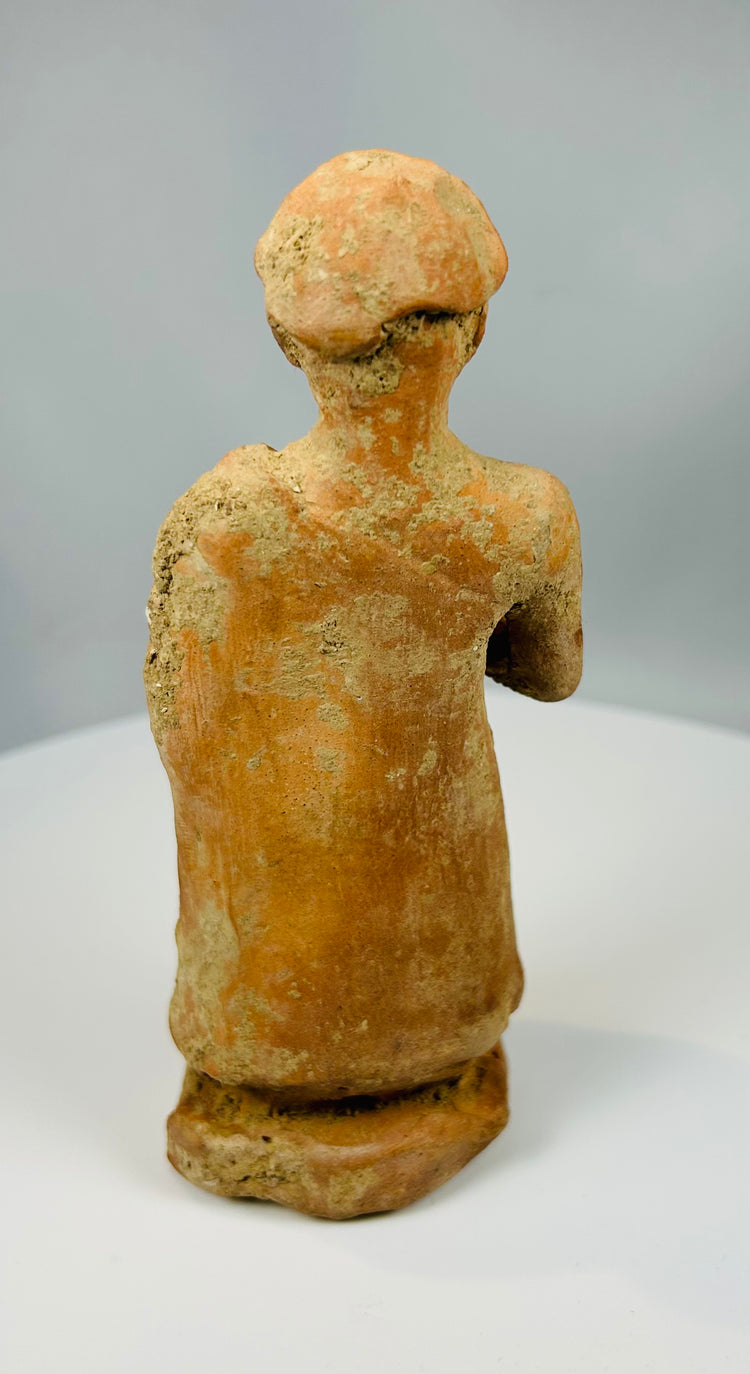 Folk-style terracotta sculpture with cap-like headdress