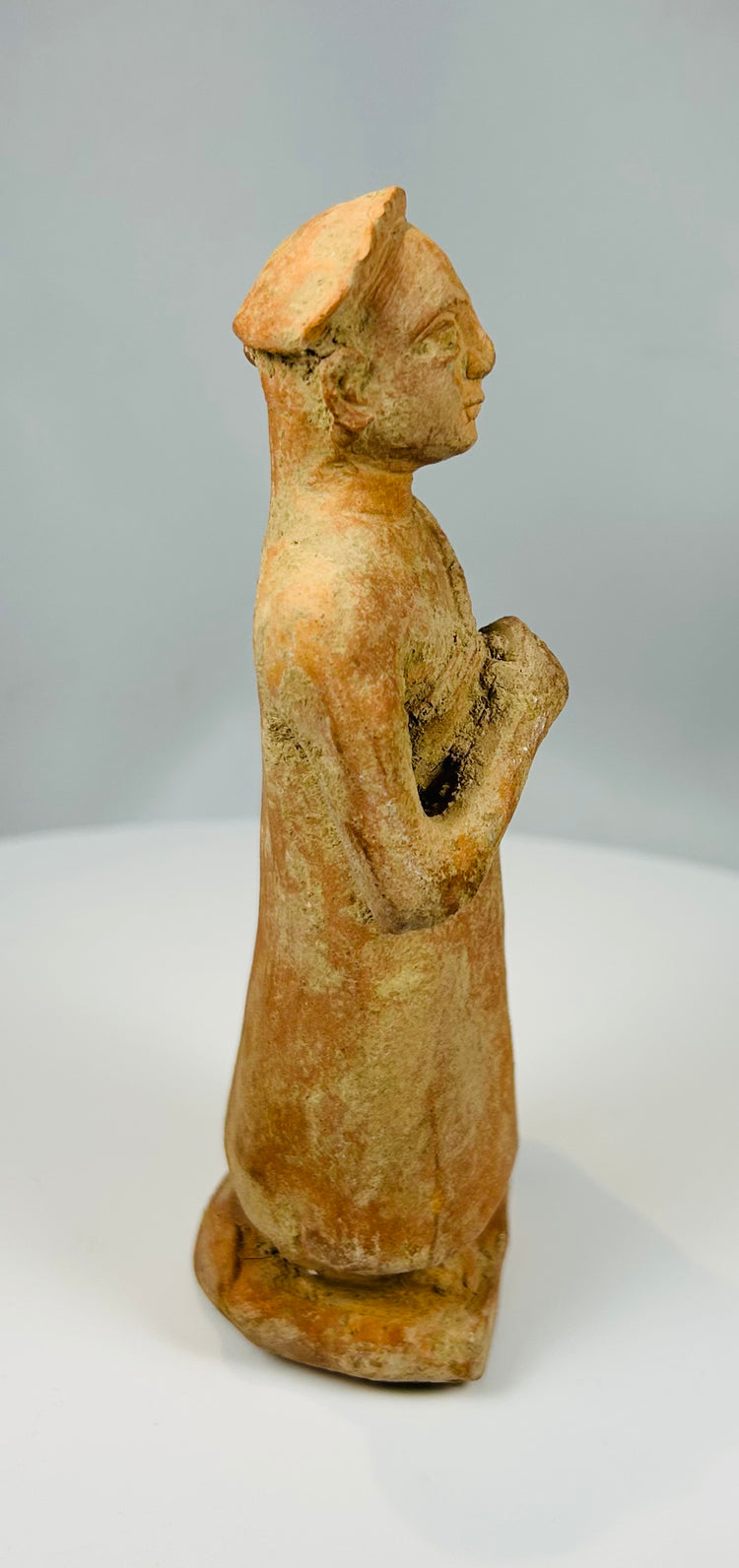 Handcrafted terracotta statue with minimal drapery detail