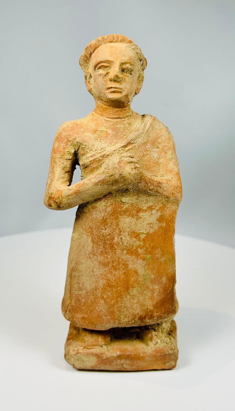 Stylized standing male figure in earthenware clay