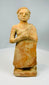 Stylized standing male figure in earthenware clay