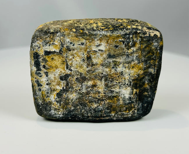 Near Eastern stone artifact with mineral deposits and aged texture