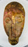 West African carved wood mask with symmetrical facial design