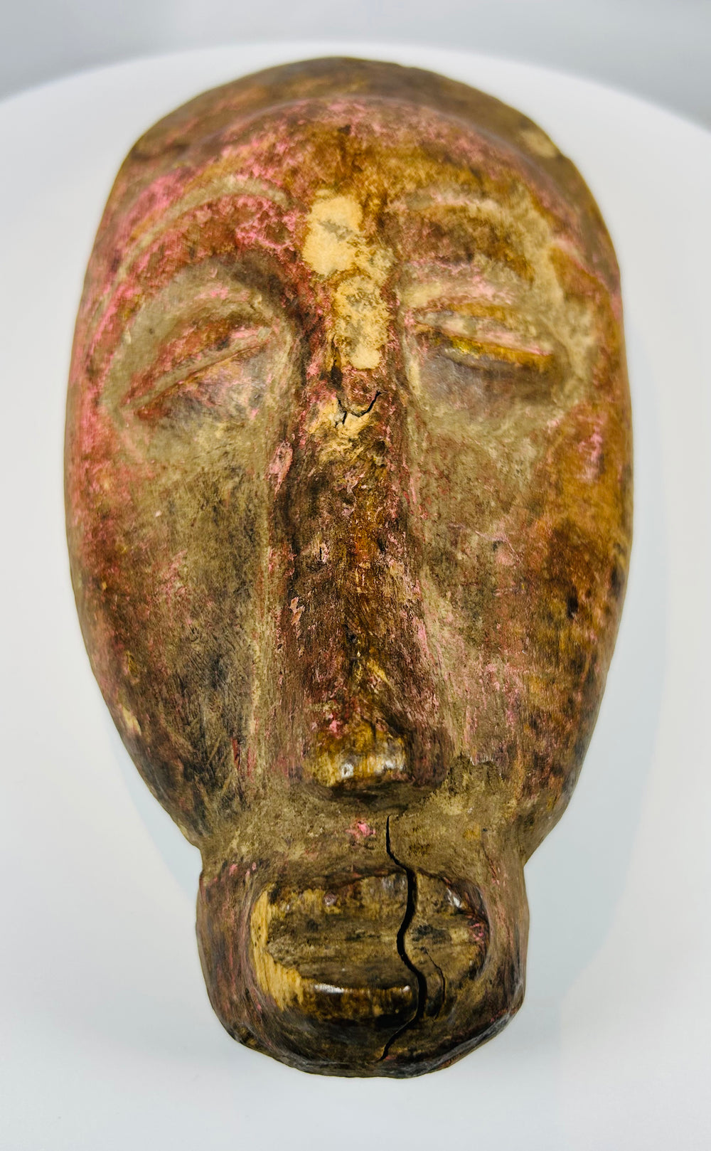Ivory Coast wooden mask with carved features and aged patina