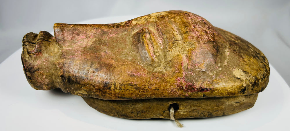 African ceremonial mask with stylized face and traces of red pigment