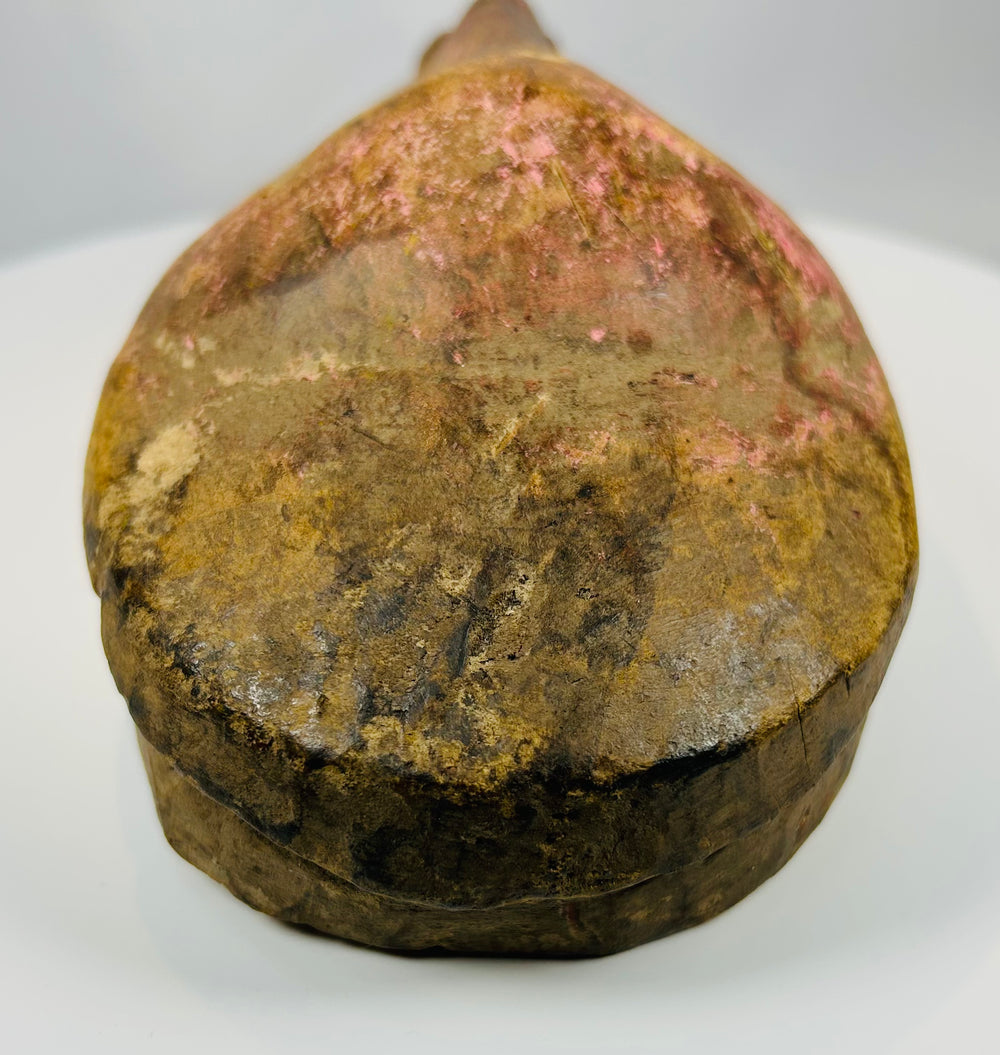 Hand carved African mask with narrow eyes and prominent nose ridge