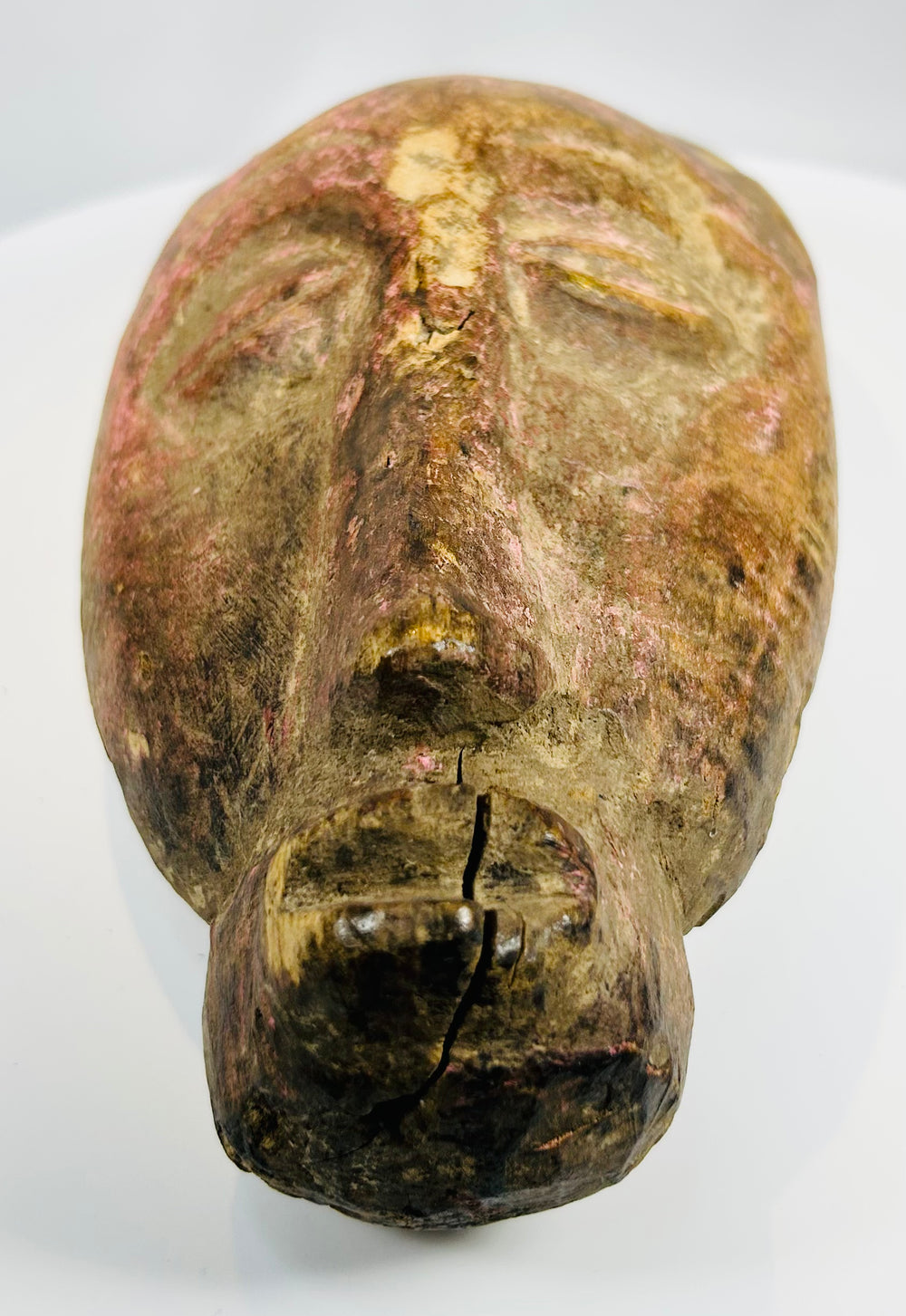 Tribal wooden mask with pigment remnants and sculptural detail