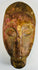 Hand carved African tribal mask with almond eyes and serene expression