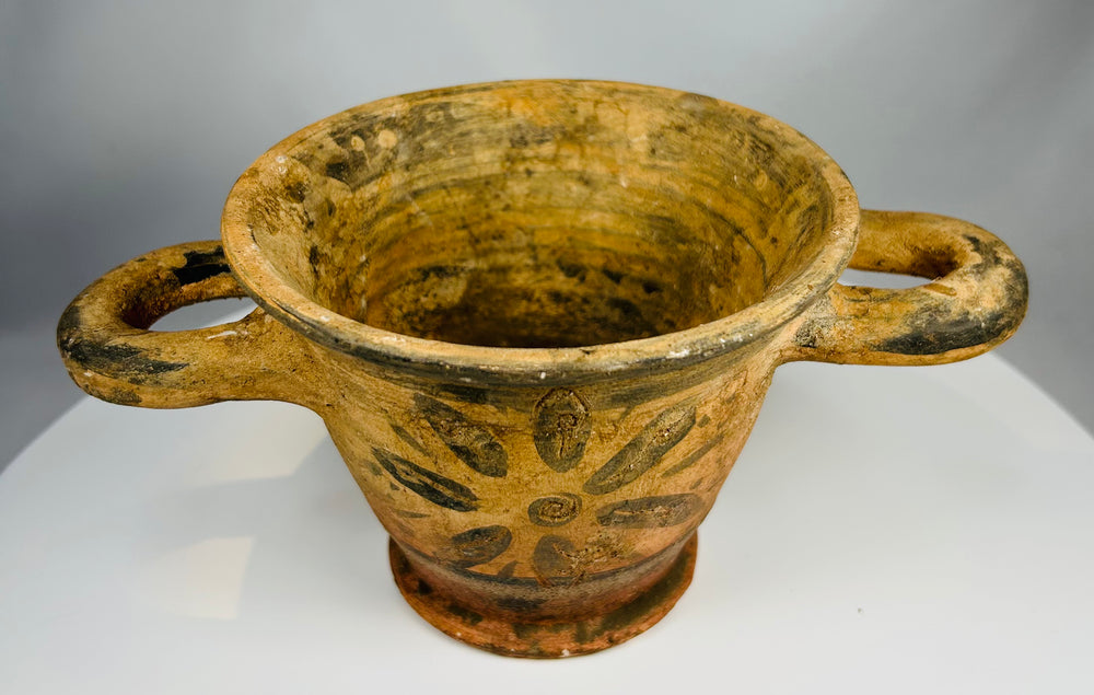 Archaic period Etruscan pottery vessel with twin handles and pedestal foot