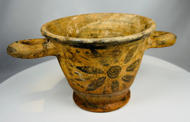 Ancient Italian terracotta vessel with mineral deposits and painted pattern