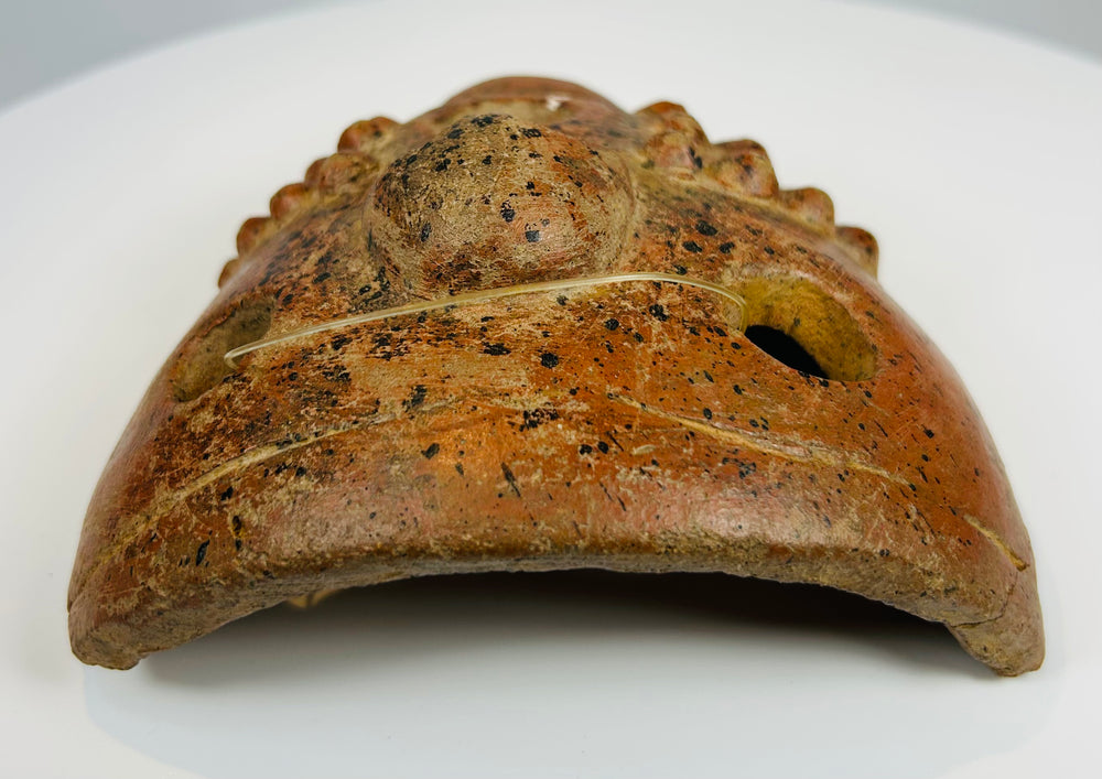 Pre-Columbian earthenware mask with concave interior and aged surface