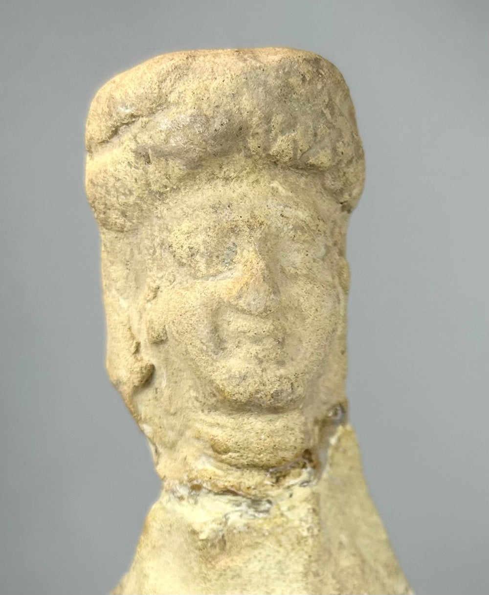Terracotta votive figure with pale clay surface and age wear