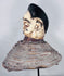 Yoruba Egungun ancestral headdress featuring black coiffure, painted wood face, and surviving costume framework.