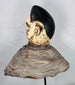 Ethnographic Yoruba Egungun mask headdress showcasing carved facial scarification and traditional masquerade construction.
