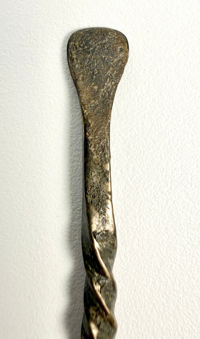 Antique Roman bronze spoon measuring approximately 5.5 inches long, with a twisted handle and shallow bowl.