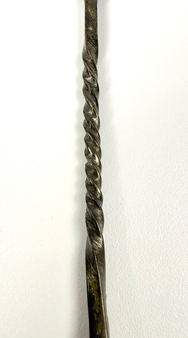 Ancient Roman bronze spoon from the Mediterranean region, featuring traditional metalwork and natural surface encrustation.