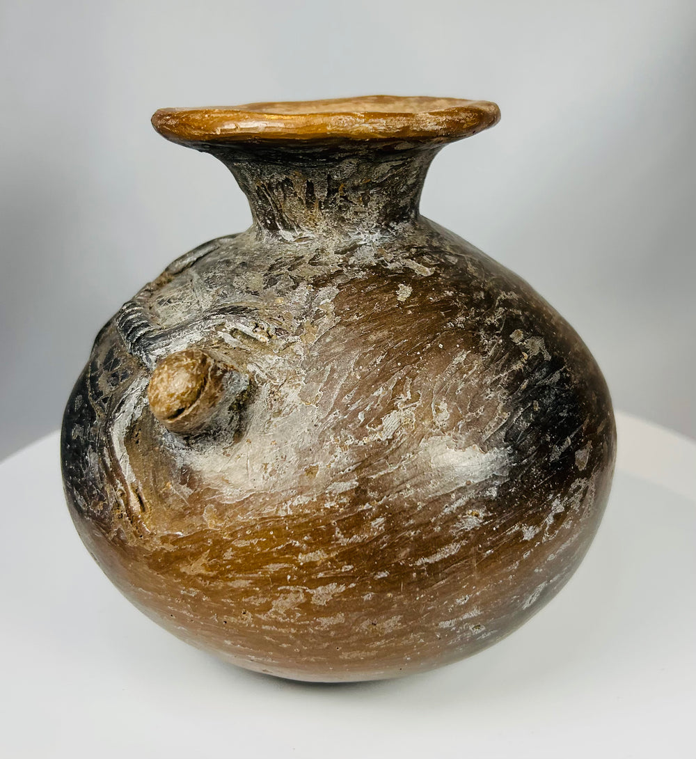 Terracotta ritual vessel with reptilian figures and burnished surface