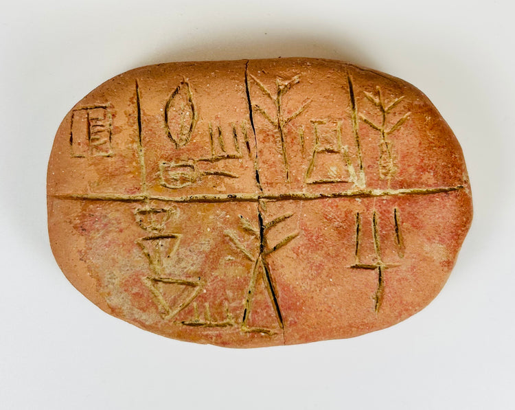 Mesopotamian record tablet with incised symbols and mineral deposits