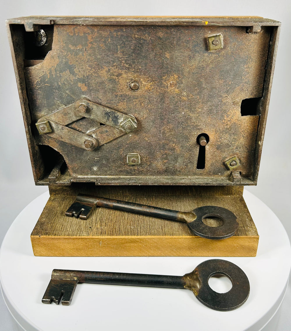 Forged iron door lock with large skeleton key and wooden mount