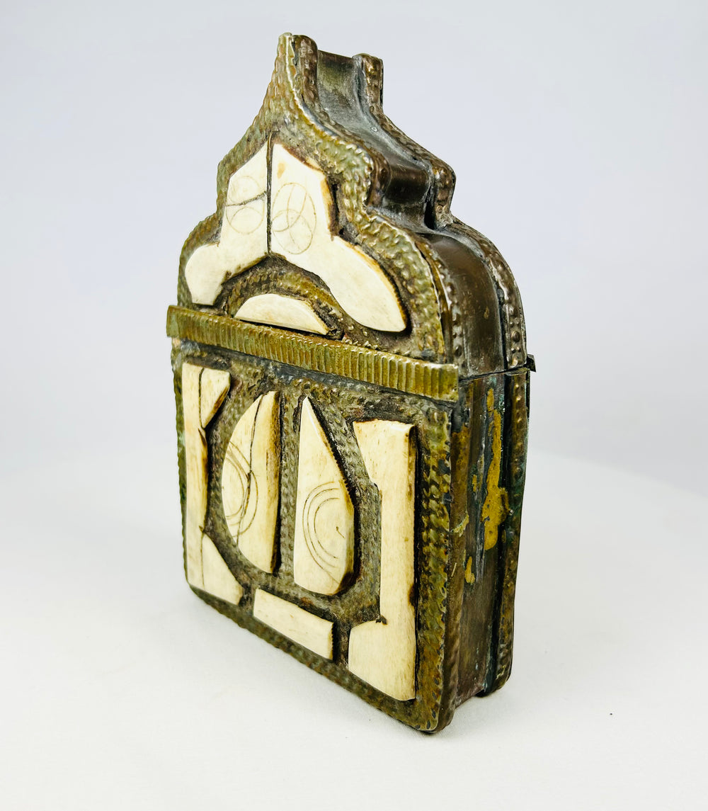 Moroccan tribal talisman box, 1800s brass body with bone inlay decoration and pointed arch lid.